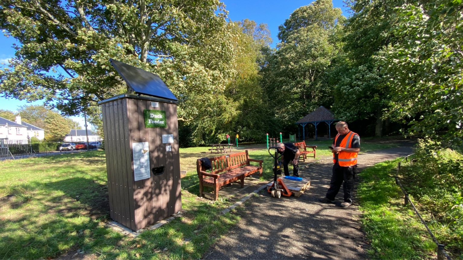 Duck feeder being installed at a park